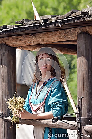 Viking woman, brunette in a blue linen dress, Stock Photo