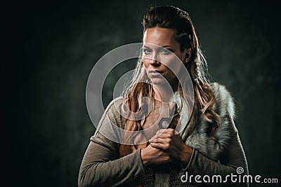 Viking woman with cold weapon in a traditional warrior clothes Stock Photo