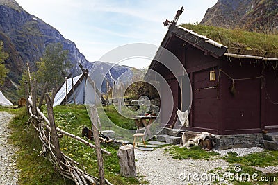 Viking Wooden house and tents in stunning Norwegian fjord landscape Stock Photo