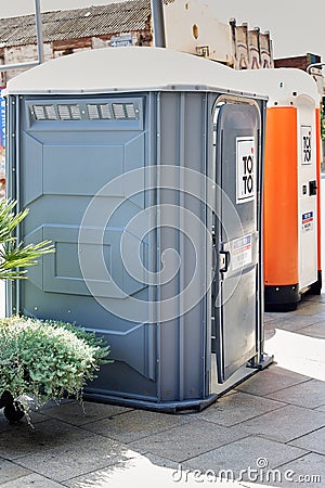 Viladecans, Spain - September 17, 2023: Portable temporary plastic bathroom for construction work on the street. Editorial Stock Photo