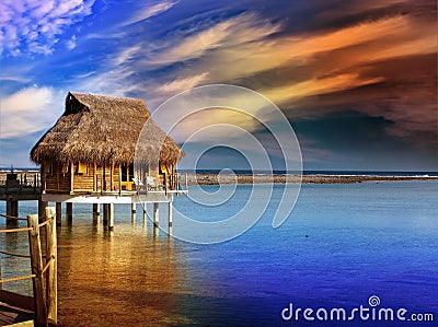 Villa on piles on water at the time sunset Stock Photo