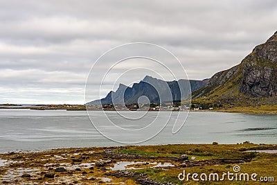 Village along the coastline and high mountains on Lofoten islands Stock Photo