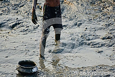 Village boy is fishing in a muddy pond stock photo Stock Photo