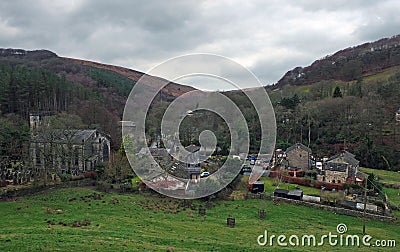 the village of cragg vale in calderdale west yorkshire showing the church and houses between high pennine hills Stock Photo