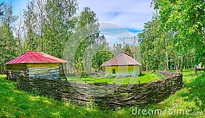 The village house and barn behind the wicker fence, Pereiaslav Scansen, Pereiaslav, Ukraine Stock Photo