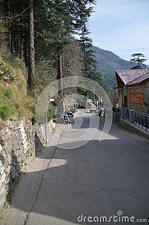 Village of Manali, India road passing through house and jungle and trees Editorial Stock Photo