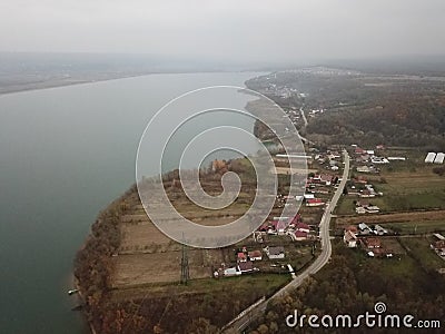 Village near the lake seen from the drone in early spring. aerial capture on a foggy day Stock Photo