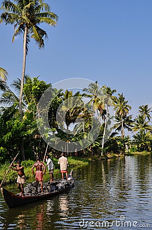 Village people carrying rocks in a boat, Kerala India. Editorial Stock Photo