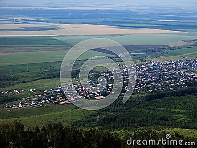 Village, small town view from above. Cottage houses among hills, fields and trees Stock Photo