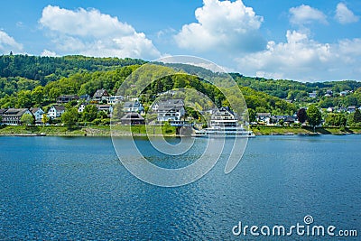 Village Rurberg at Eifel National Park, Germany. Scenic view of lake Rursee and houses in the background Stock Photo