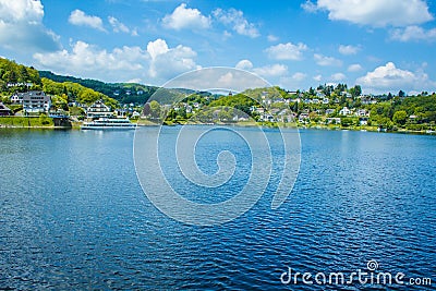 Village Rurberg at Eifel National Park, Germany. Scenic view of lake Rursee and houses in the background Stock Photo