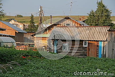 A village in Russia in summer, an original old wooden village house, an original authentic disappearing village life. Rural landsc Stock Photo