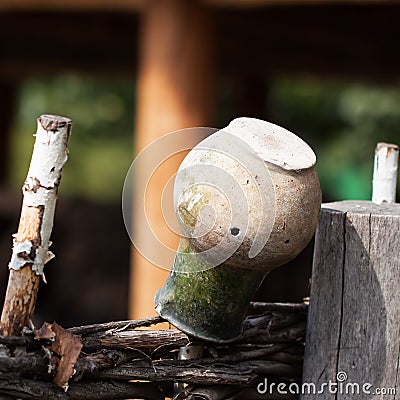 Village,rustic wattle fence, old clay jug. Rural scene Stock Photo