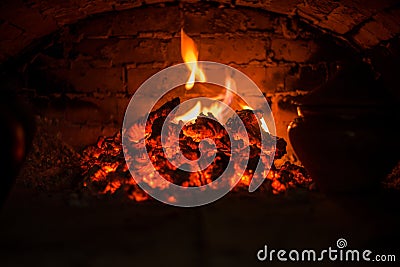 Village stove firewood and fire. Burning wood inside traditional oven Stock Photo