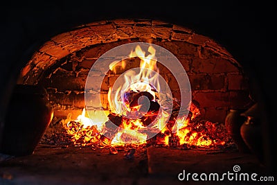 Village stove firewood and fire. Burning wood inside traditional oven Stock Photo