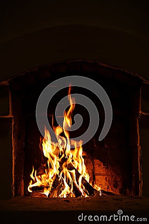 Village stove firewood and fire. Burning wood inside traditional oven. Stock Photo