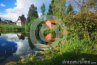 Village summer lake with cloud reflections background Stock Photo