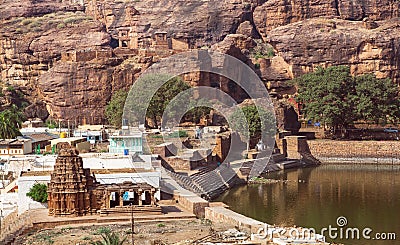 Village with 7th century Hindu temple in front of mountains in town Badami, India Stock Photo