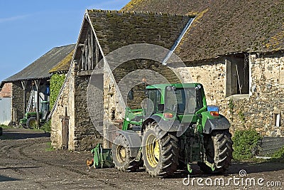 Village view old farm and new tractor Editorial Stock Photo