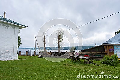 Green grassy lawn in the courtyard of the Holy Cross Church, 07/18/2019, the village of Vozdvizhenie, Ivanovo region, Russia Editorial Stock Photo