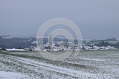 village Welling with the dark church tower during winter snow Stock Photo