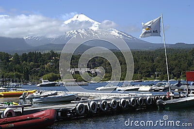 Villarrica, one of the most active volcanoes in Chile, seen from Pucon.with boat marina with luxurious architecture.may 2016 Editorial Stock Photo