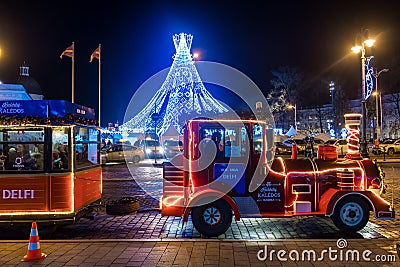 Christmas train and Christmas tree at Cathedral Square in Vilnius at night Editorial Stock Photo