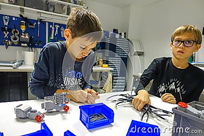 Vilnius, Lithuania - November 23, 2018: Kids making Lego robot mindstorms. Robotic, learning, technology, stem education Editorial Stock Photo