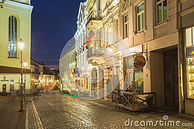 Vilnius Lithuania. Pilies Street Of Old Town In Bright Evening Illumination, Ancient Architecture Editorial Stock Photo