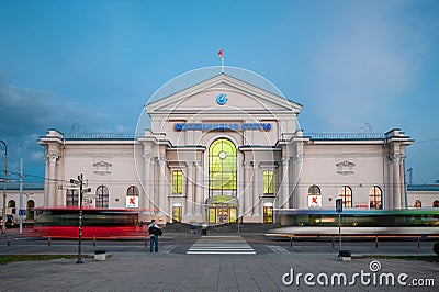 VILNIUS, LITHUANIA - SEPTEMBER 12, 2018: Vilnius Cityscape And Railway Station in Background. Blurry Public Transport Trolley and Editorial Stock Photo