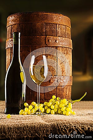 Vine composition old barrel with wineglass bottle and winegrape Stock Photo