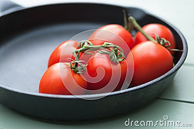 Vined Tomatoes in Pan Stock Photo