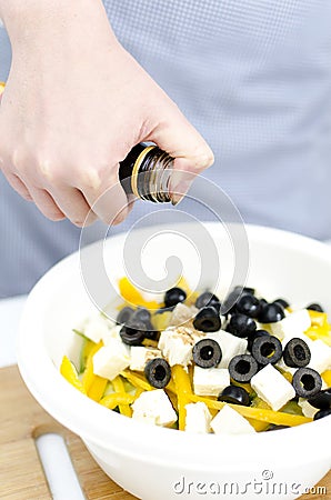 Vinegar pours on greek salad Stock Photo