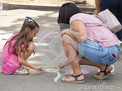 Vinnitsa, Ukraine. 08/24/2019. Children draw on the pavement with chalk Editorial Stock Photo