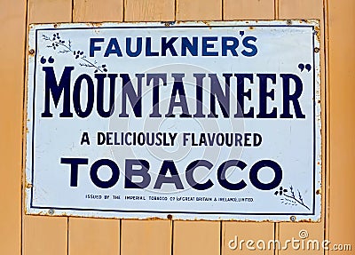 Vintage enamel advertising. Faulkner`s Mountaineer Tobacco Editorial Stock Photo