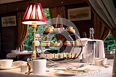 Vintage afternoon tea stand through window of train compartment Stock Photo