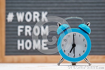 vintage alarm clock on the background of English text work from home Stock Photo