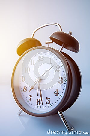 Vintage alarm clock showing almost half past seven in morning Stock Photo