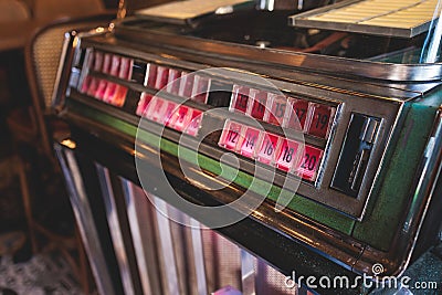 Vintage American music jukebox with illuminated buttons, process of choosing song composition, retro old-fashioned juke-box with Stock Photo