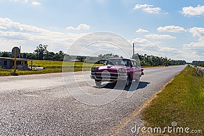 Vintage American retro car on rural road. Cuba Vinales valley Editorial Stock Photo