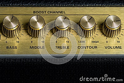 Vintage amplifier five knobs horizontal closeup, music recording studio equipment, bottom copy space Stock Photo