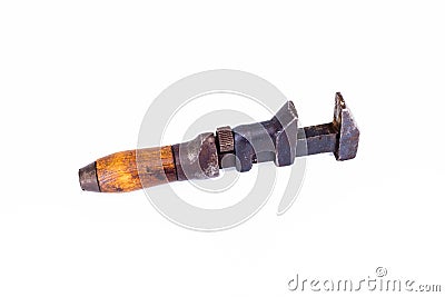 Vintage antique rusty plumber monkey wrench with a wooden handle isolated on white background Stock Photo