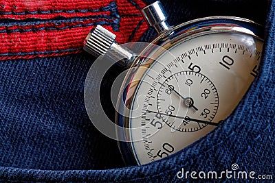 Vintage antiques Stopwatch, in dark blue jeans pocket, value measure time, old clock arrow minute, second accuracy timer record Stock Photo