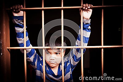 Vintage of asian boy Hand in jail Stock Photo