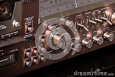 Vintage Audio Stereo Gear Setup Copper Front Panel with Multiple Controls Including Display, Knobs, Buttons, Keys, Switches Stock Photo