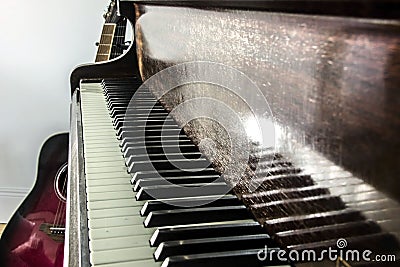 Pianoforte keyboard and a guitar. Stock Photo