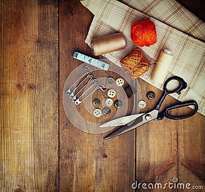 Vintage Background with sewing tools and sewing kit over wooden textured background Stock Photo