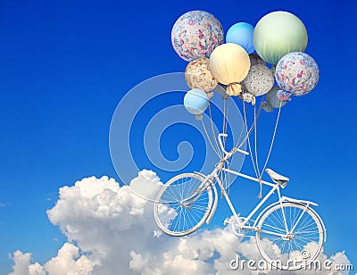 Vintage bicycle flying up into the sky with balloons Stock Photo