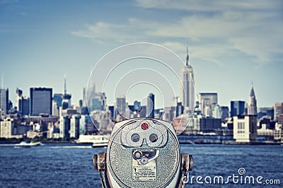 Vintage binoculars viewer, Manhattan skyline with the Empire State Building, New York City USA Stock Photo