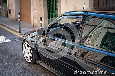 Vintage black Ford Escort RS Cosworth MK5 rally sports car parked on the street in Soller, Spain Editorial Stock Photo